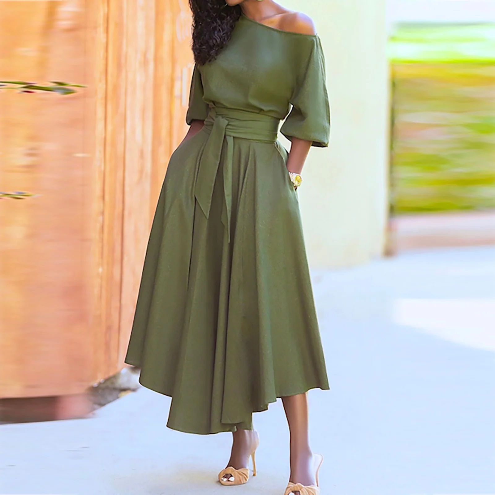 Woman in a sage green cocktail dress